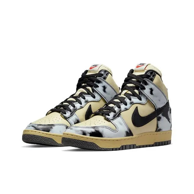 Nike Dunk High high-top sneakers, light yellow and white uppers with black swoosh and panels.