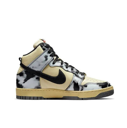 Nike Dunk High high-top sneakers with black swoosh, black patches, and light yellow leather base.