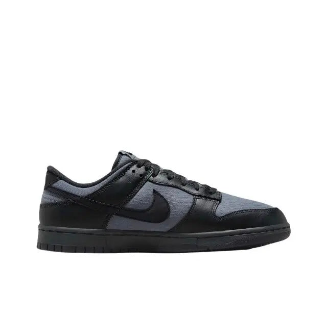 Low-top sneaker side view with black swoosh and gray toe panel