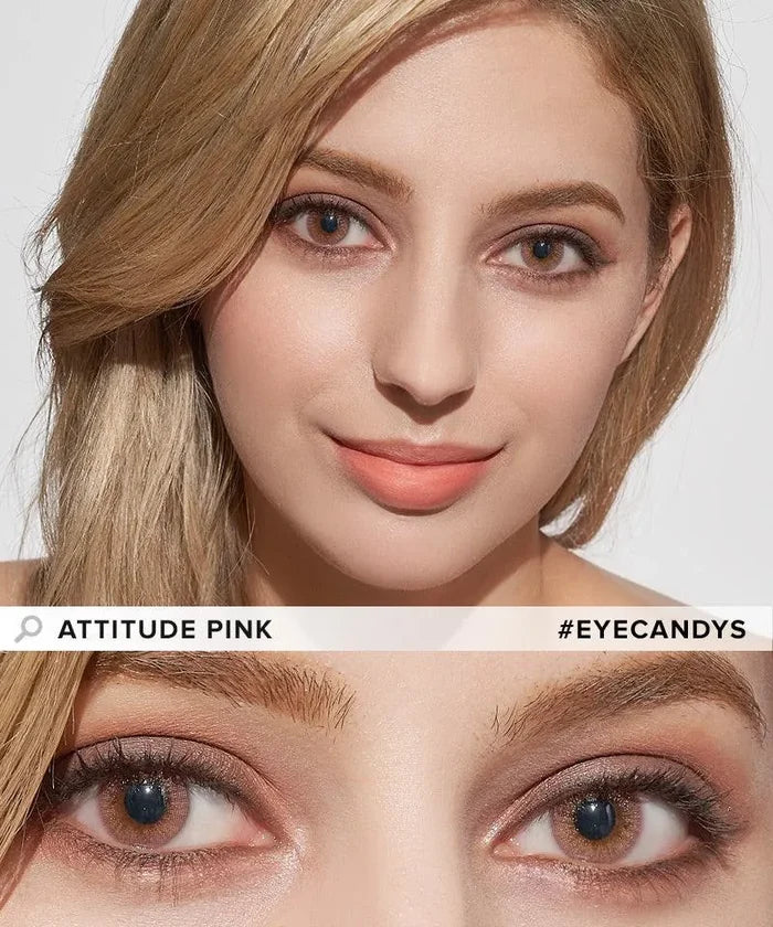 A woman with light brown hair wears pink-toned makeup and soft pink lipstick, complemented by EyeCandys Attitude Glitter Pink colored contacts. Close-up of her face and eyes. Text: "EyeCandys Attitude Glitter Pink" and "#EYECANDYS".