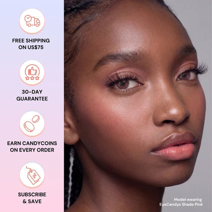 A woman with glowing skin and pink makeup looks ahead, wearing EyeCandys Shade Pink natural-looking contacts. Icons left show free shipping over $75, 30-day guarantee, CandyCoins rewards, and subscribe & save.