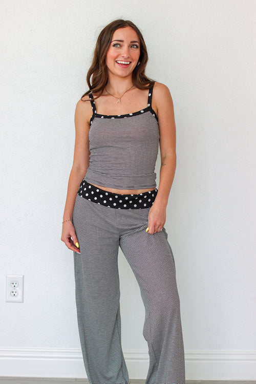 Woman wearing a black and white striped polka dot outfit set