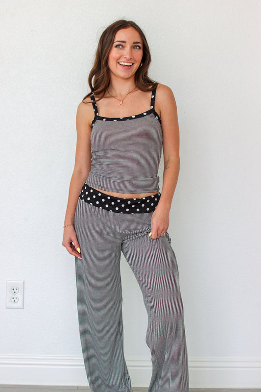 Woman wearing a black and white striped polka dot outfit set