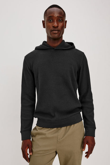 Gates Hoodie in Micro-Waffle Cotton Blend With Fixed Hood, Long Sleeves, and Relaxed Fit in Onyx Colorway - Upper Body Front View Featured on Model