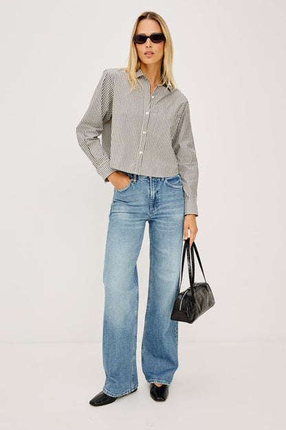 Fremont Low Rise Bootcut Jean in Light Stretch Denim With Extended Inseam, 5-Pockets, Distressed Details, Belt Loops, and Zip-Fly Closure in Wild West Colorway - Full Body Front View Featured on Model