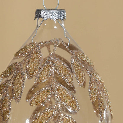 Decorative hanging ornament with gold leaf pattern on a beige background