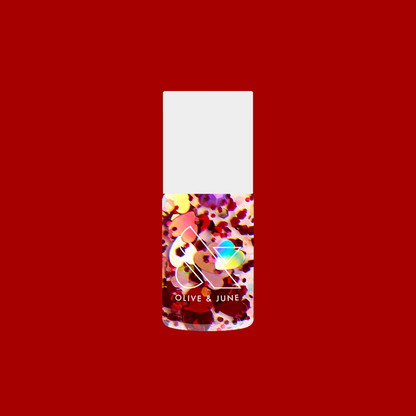 Bottle of HEARTED quick dry polish filled with heart and sequin confetti by Olive and June on a solid red background