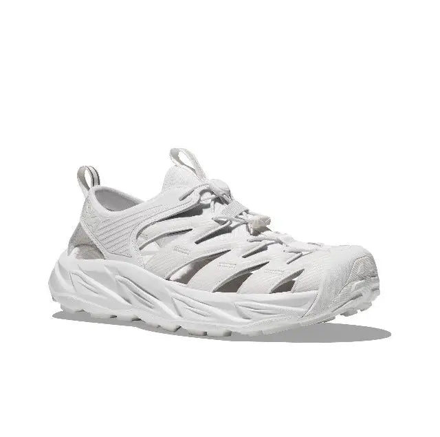 White lace-up sneaker with side vent cutouts, chunky midsole, and grippy outsole