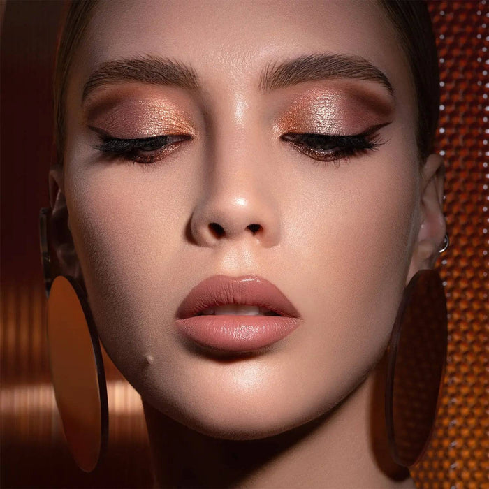 I Need a Warm Eyeshadow Palette model look on a bronze background.
