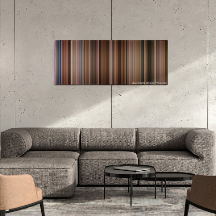 Jerry Maguire color palette canvas on a concrete wall above a gray sectional sofa