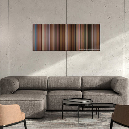 Jerry Maguire color palette canvas on a concrete wall above a gray sectional sofa