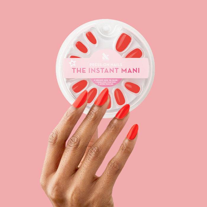 Lava - Press-On | Medium | Almond showing hand with medium almond press-on nails in spicy orange red polish