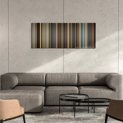 Legend color palette canvas on a concrete wall above a gray sectional sofa
