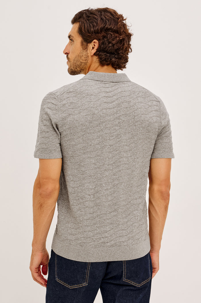 Linden Polo Shirt in Cotton Knit With Subtle Diamond Texture, Classic Fit, Quarter Button Placket, Short Sleeves, and Ribbed Trim in Heather Grey Prism Colorway - Upper Body Back View Featured on Model