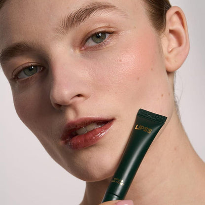 Close-up of a woman's face with a lip gloss Lipss Smells like money