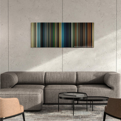 Maleficent color palette canvas on a concrete wall above a gray sectional sofa