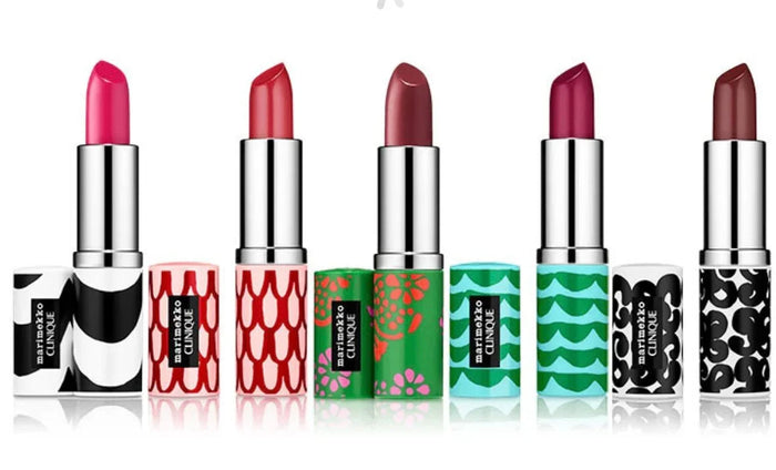 Six colorful lipsticks with patterned tubes in various pink and red shades, displayed in a row.