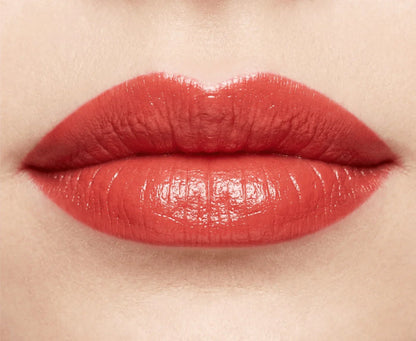 Close-up of lips wearing glossy poppy red lipstick, beauty makeup focus