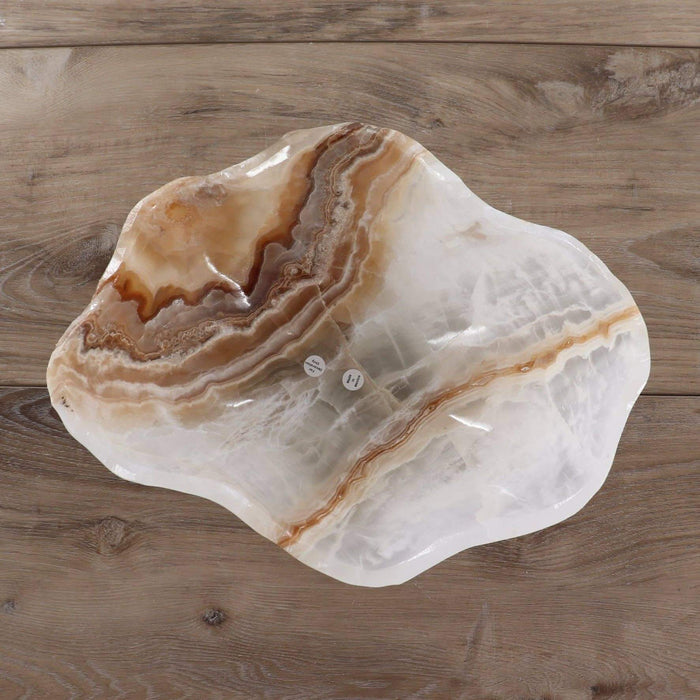 Hand-carved Mexican Onyx/Calcite Bowl 12" with rich amber and honey-toned banding on a wooden background.