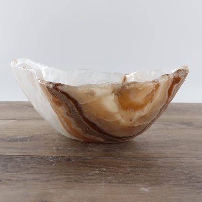 Mexican Onyx/Calcite Bowl 12" displayed on wooden surface showcasing rich amber and honey banding.