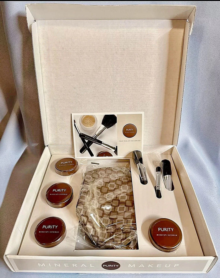 Mineral powder foundation set with brushes, makeup bag, and medium shade containers in box.
