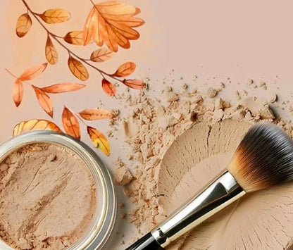 Mineral powder foundation in medium shade with makeup brush and autumn leaves on beige background