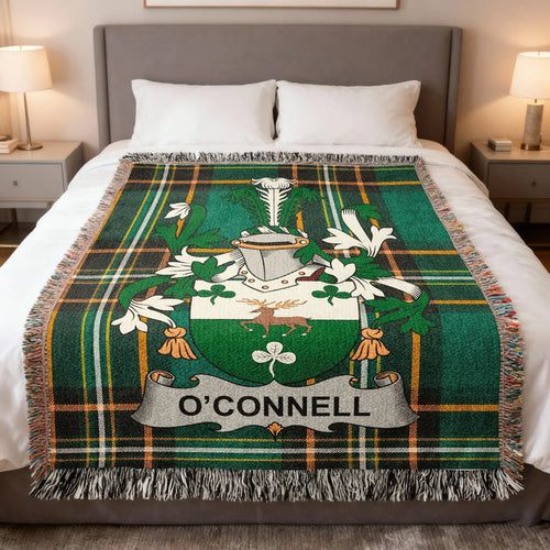 O'Connell family crest woven blanket laid across a bed.