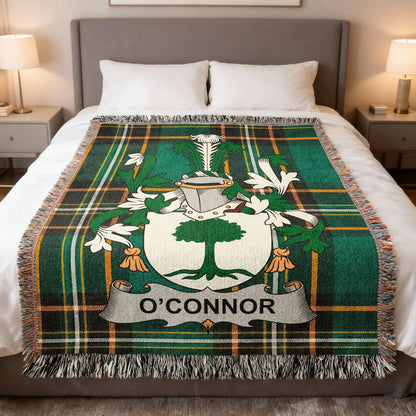 O'Connor family crest woven blanket draped across a bed.