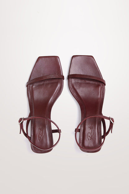 Palma Sandal Heel in Top-Grain Leather With Single Toe Strap, Adjustable Buckled Wrap Ankle Strap, and Low Heel in Burgundy Colorway - top view of shoe.