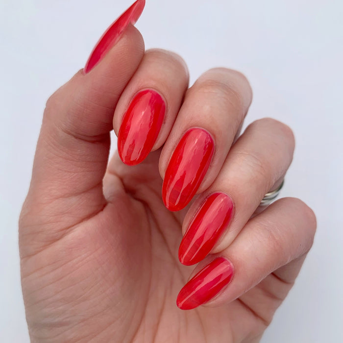 A hand with medium-length almond nails painted in LONDONTOWN’s Perfecting Nail Veil #8, shown against a plain white background, exudes bold confidence and care with its polished, power-packed hint of color.