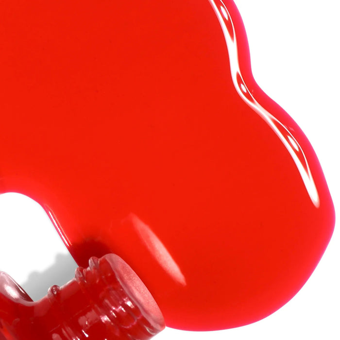 LONDONTOWN’s Perfecting Nail Veil #8, in a vibrant red shade, spilled from an open bottle onto a white surface.