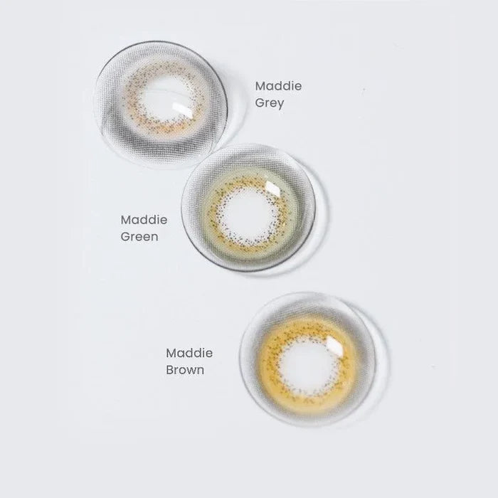 Assortment of Maddie prescription colored contact lenses in various shades: grey, green and brown on a white background.