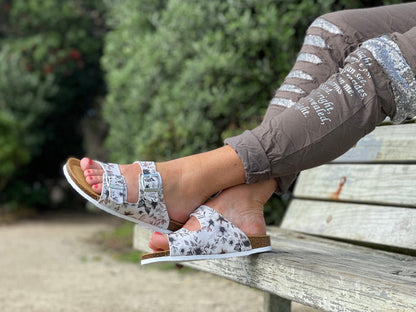 European made women's sandals. comfortable contoured cork footbed slide sandals. Quality leather sandals. In white floral print.