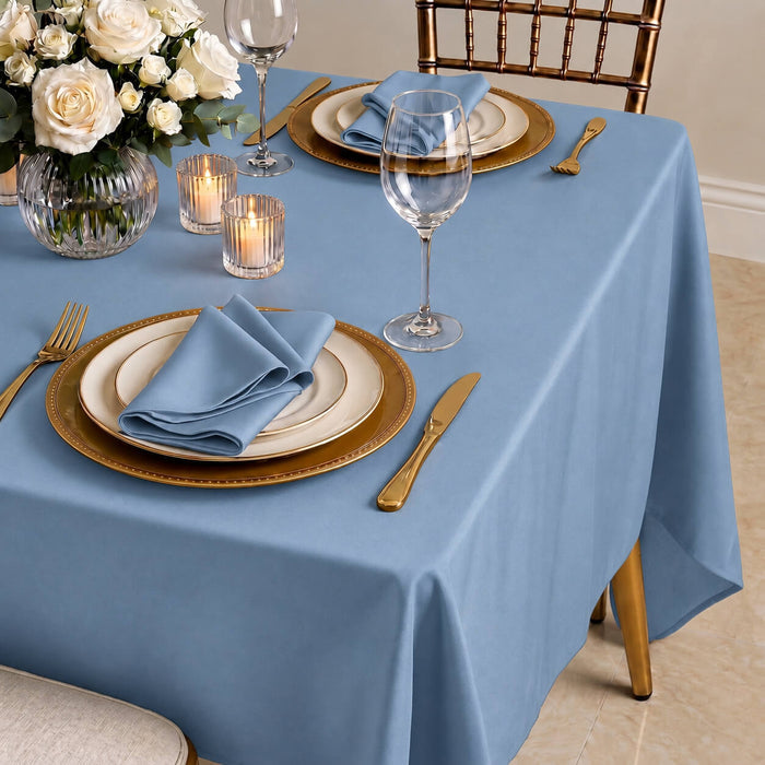 Dusty blue rectangular tablecloth with wrinkle-resistant finish on elegantly set table.