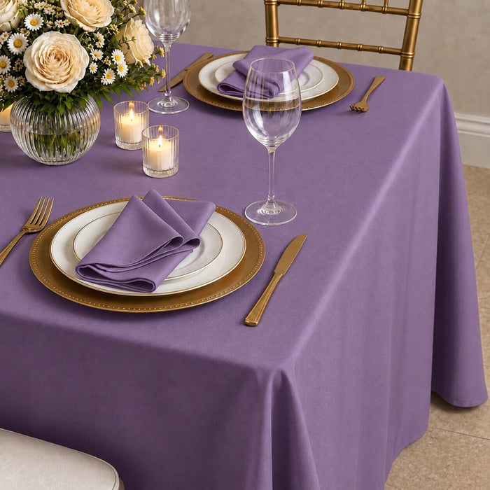 Violet amethyst tablecloth on elegantly set dining table.