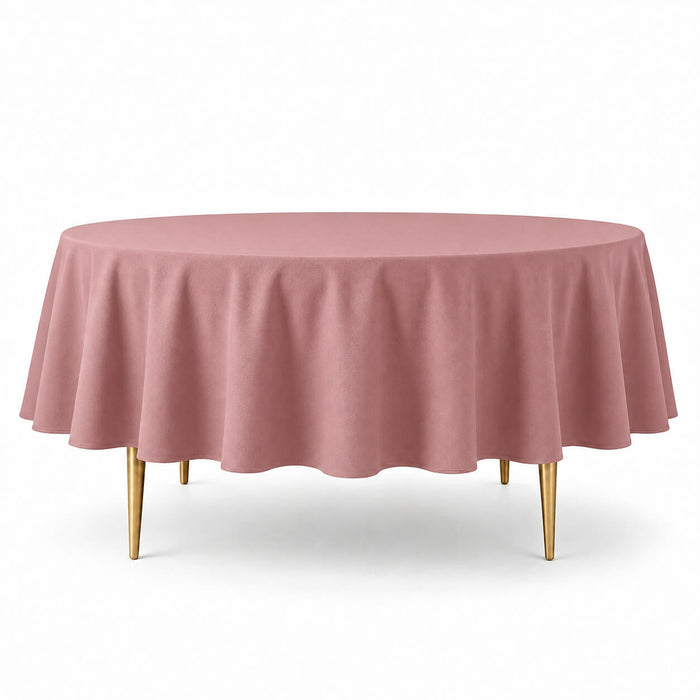 Dusty rose polyester round tablecloth on a round table with gold legs.