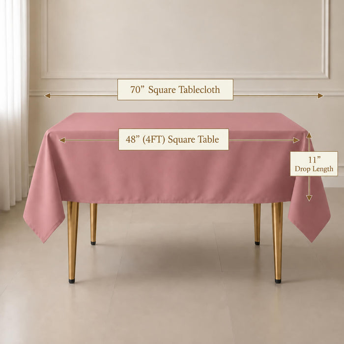 A dusty rose square tablecloth draped over a rectangular table in a bright room, with measurement labels showing 70" square tablecloth, 48" by 4FT table, and 11" drop length.