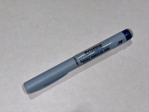 A gray Pristine Medical Simu Insulin Pen rests on a light gray surface.