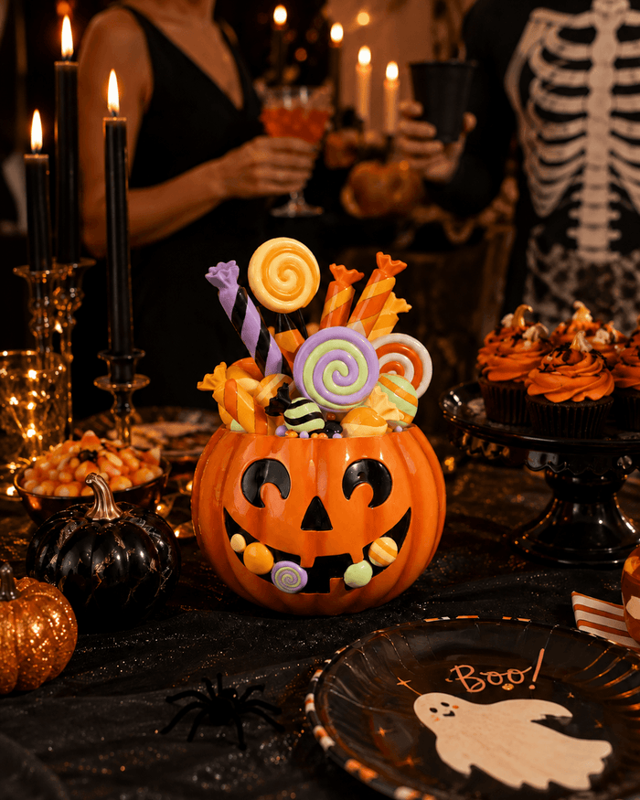 Pumpkin Candy Display featuring a resin jack-o'-lantern filled with colorful faux candies on a festive Halloween table.