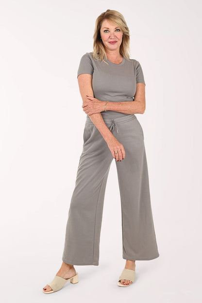 Woman wearing a two piece lounge set in grey