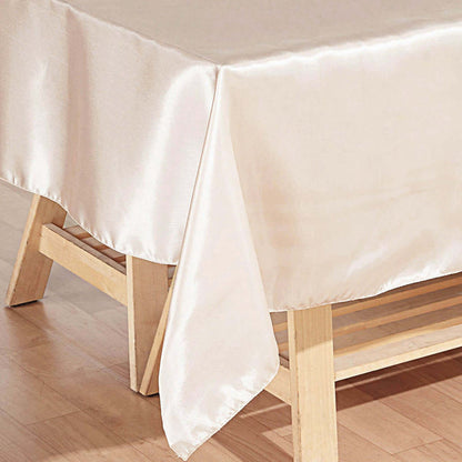 Elegant satin tablecloth draping over a wooden table.