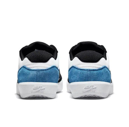 Black and blue heel and collar view of a low-top skate sneaker with white panels.