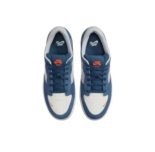 Blue and white low-top skate sneakers, side with orange and white logo on tongue