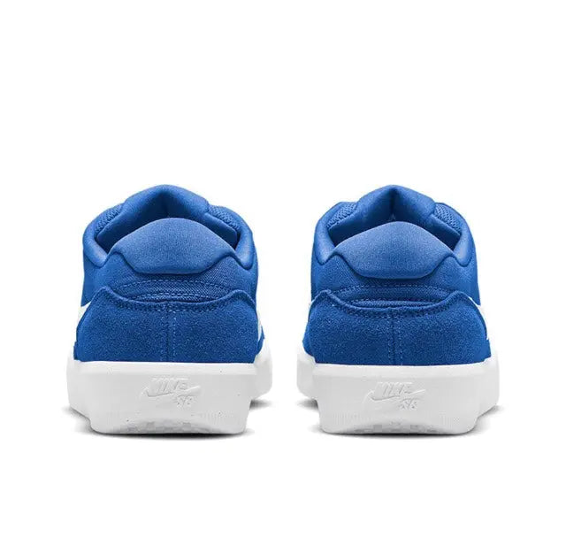 Blue low-top sneaker heel view with padded collar and white rubber sole.