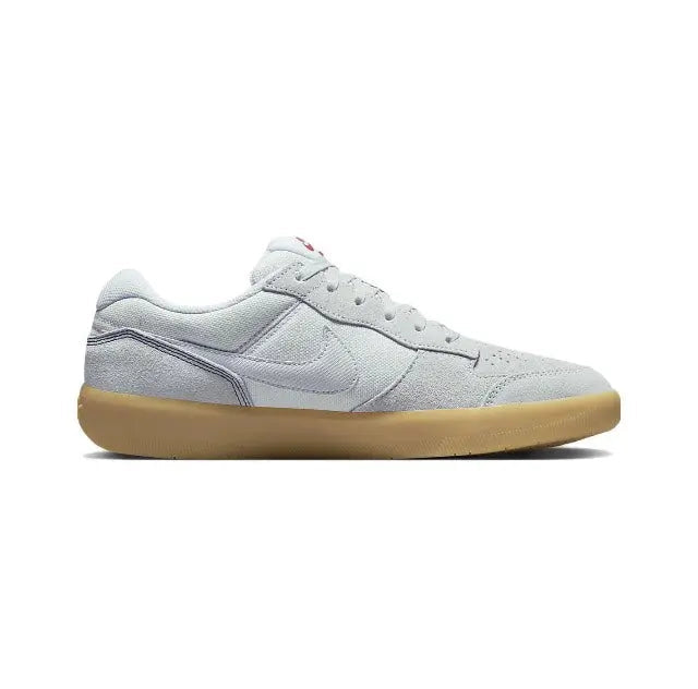 Light grey skate shoe side profile with gum sole and stitched paneling