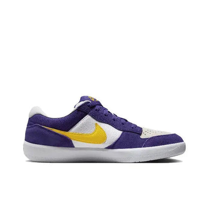 Side view of purple low-top sneakers with yellow swoosh and white midsole