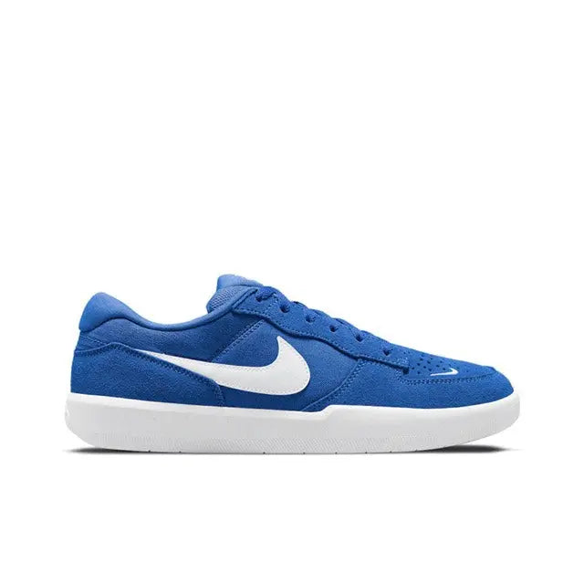 Blue low-top skate sneaker side view, white Swoosh and white rubber sole.