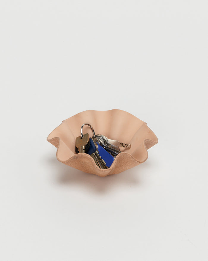 Leather Shell Bowl by Hender Scheme in small  with keys in bowl on a gray  background