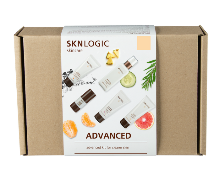 SKNKIT009 SKNLOGICClearer Skin Retail Kit | A SKNLOGIC skincare Advanced Clearer Skin kit in a cardboard box, featuring various skin care products and the brand's logo.