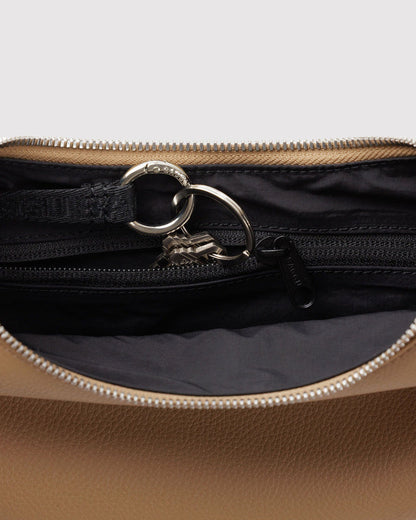 Zip-top lining detail with metal ring and chunky zipper on recycled leather crescent bag